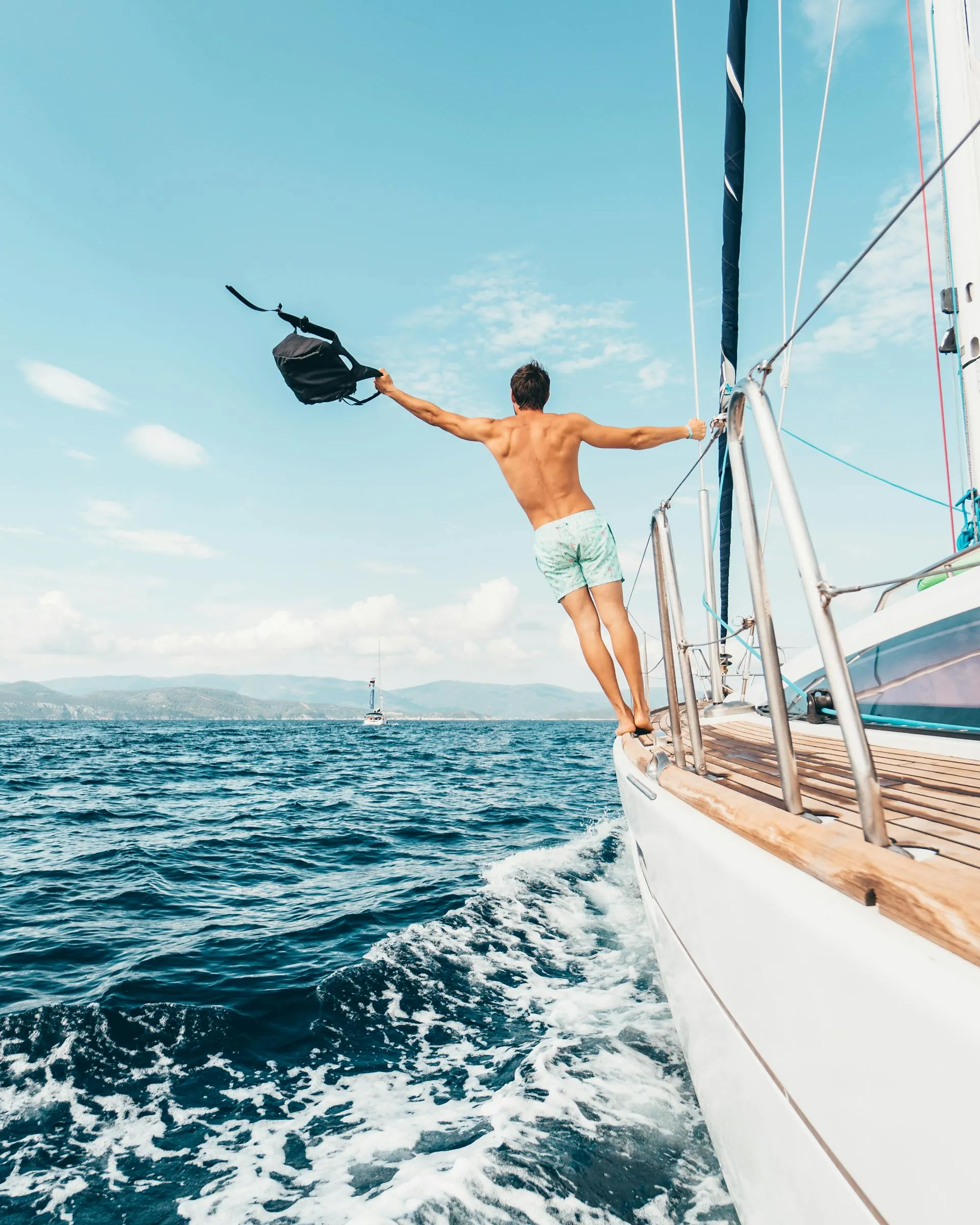 Charter guest on the bow of a sailing yacht in the Mediterranean