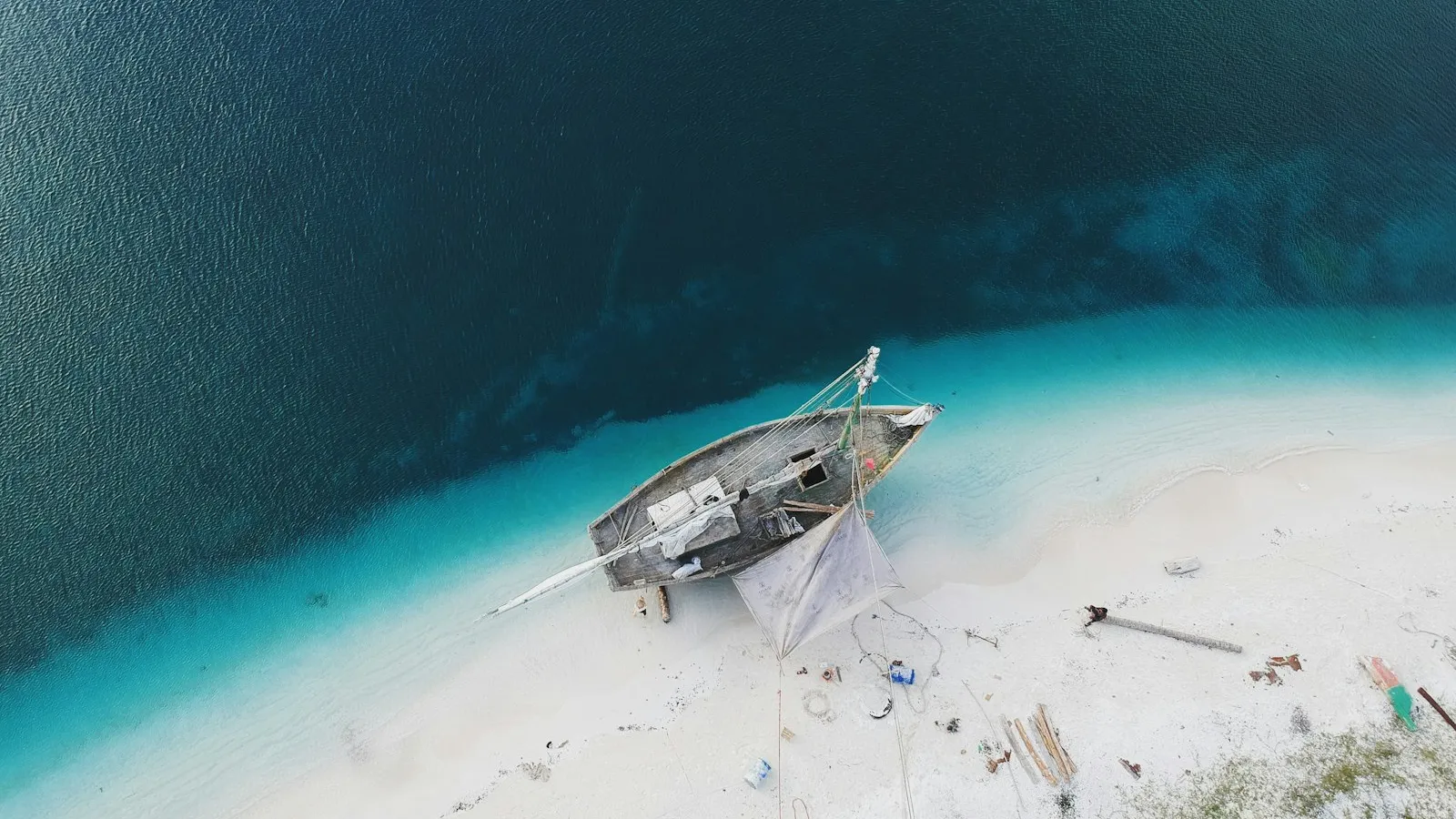 Beached sailing boat on white sand — the insurance risk every operator wants to avoid