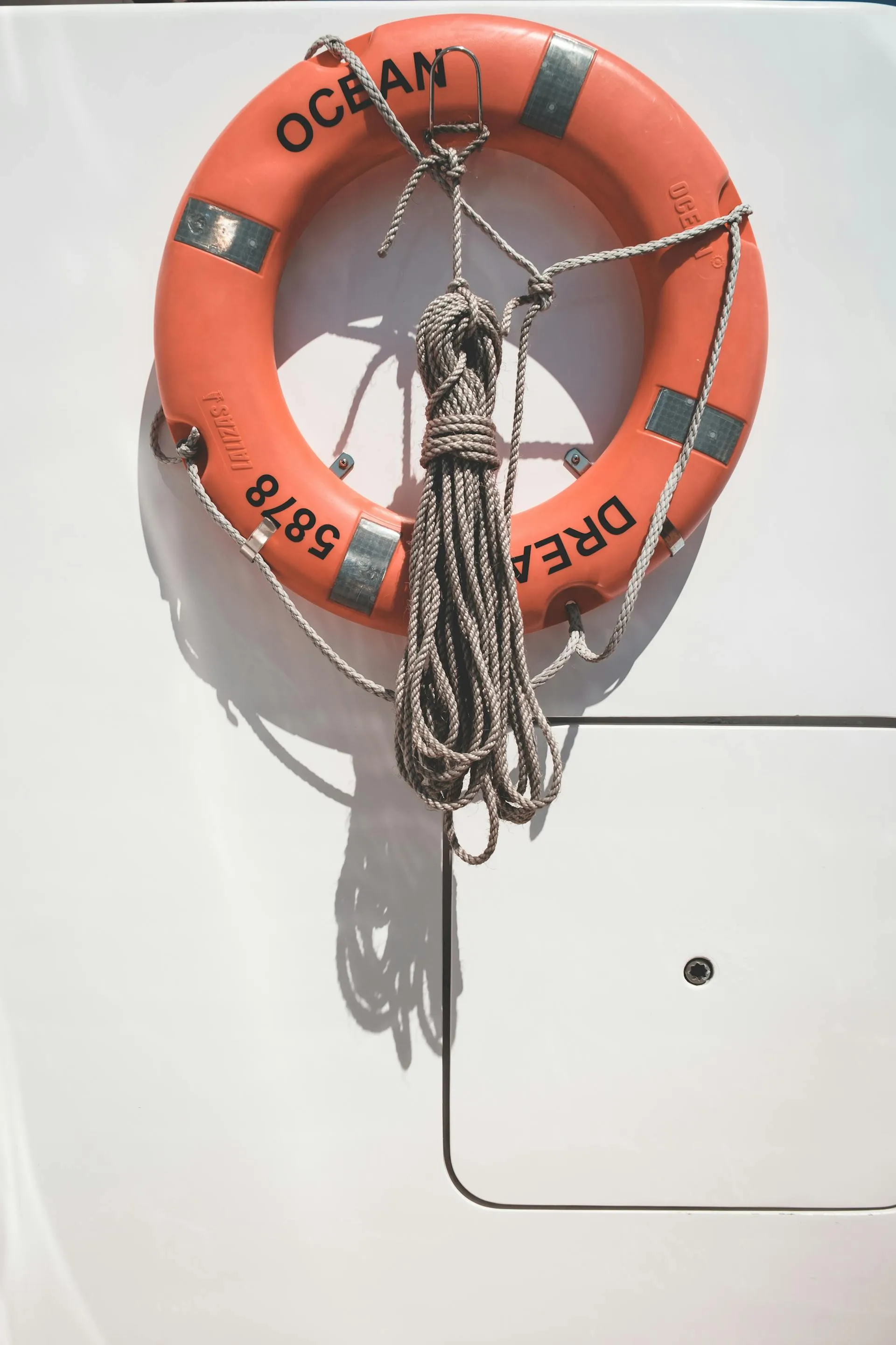 Lifebuoy and safety rope on a yacht deck